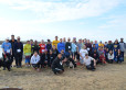 Runners gather at the river for a group shot.